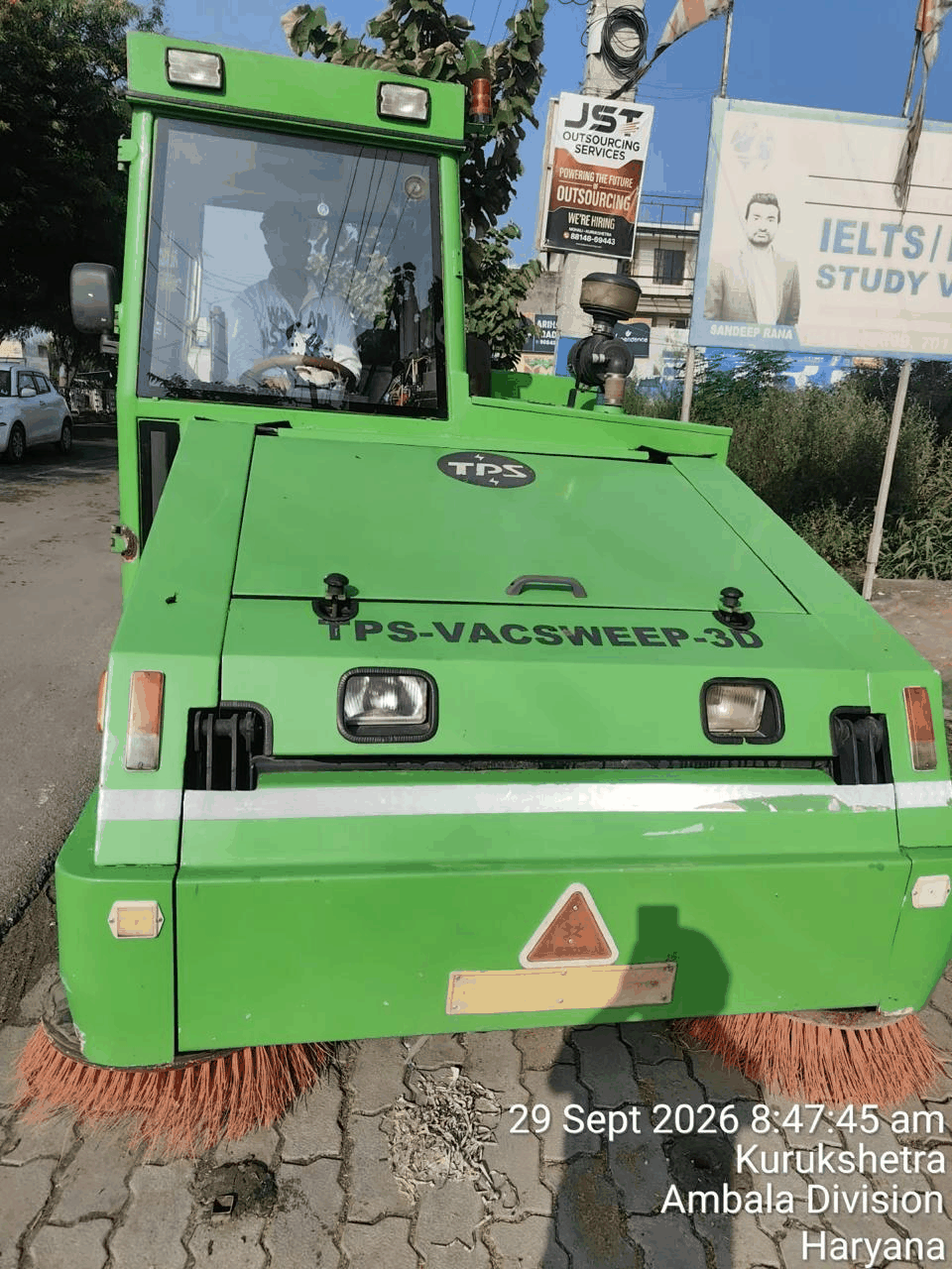 Front view of the S.S. Solutions sweeping machine on its route in Kurukshetra